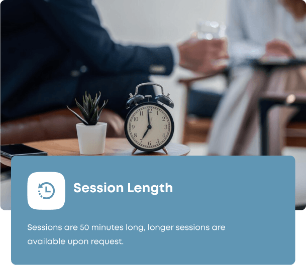 A Clinical Counsellor monitoring the session length of a client with an alarm clock on his desk.