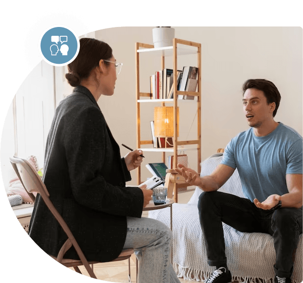 A Registered Clinical Counsellor providing therapy to a woman in a bedroom.