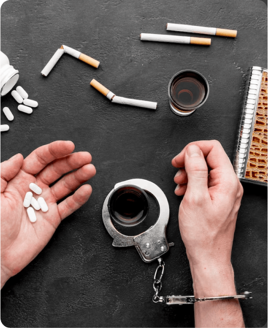 A hand holding a cup of coffee and a hand with a handcuff, symbolizing the complex relationship between mental health and confinement.