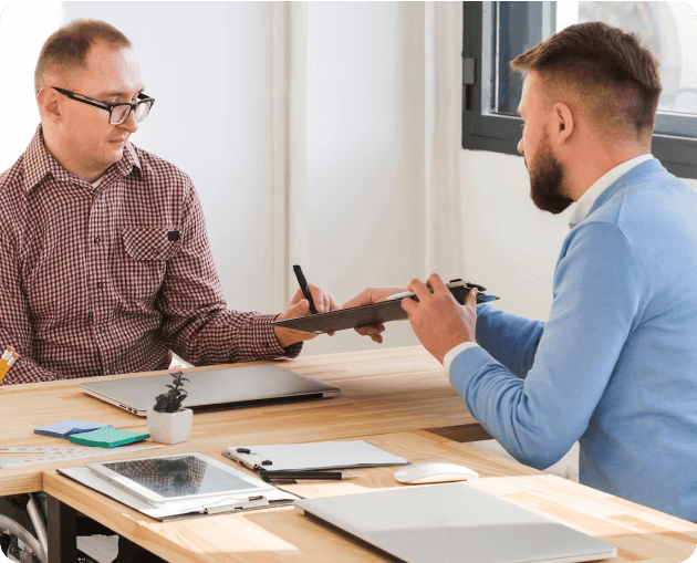 Two men engaging in divorce counseling at a desk.