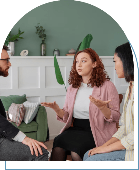 Three people engaging in a therapeutic conversation, addressing mental health concerns, while seated in a circle.
