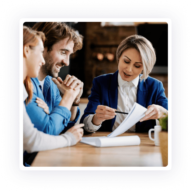A group of Clinical Counsellors sitting around a table looking at papers.