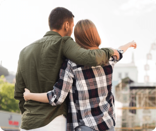 A couple embracing in front of a ferris wheel portrays intimacy in the context of couples and family therapy.