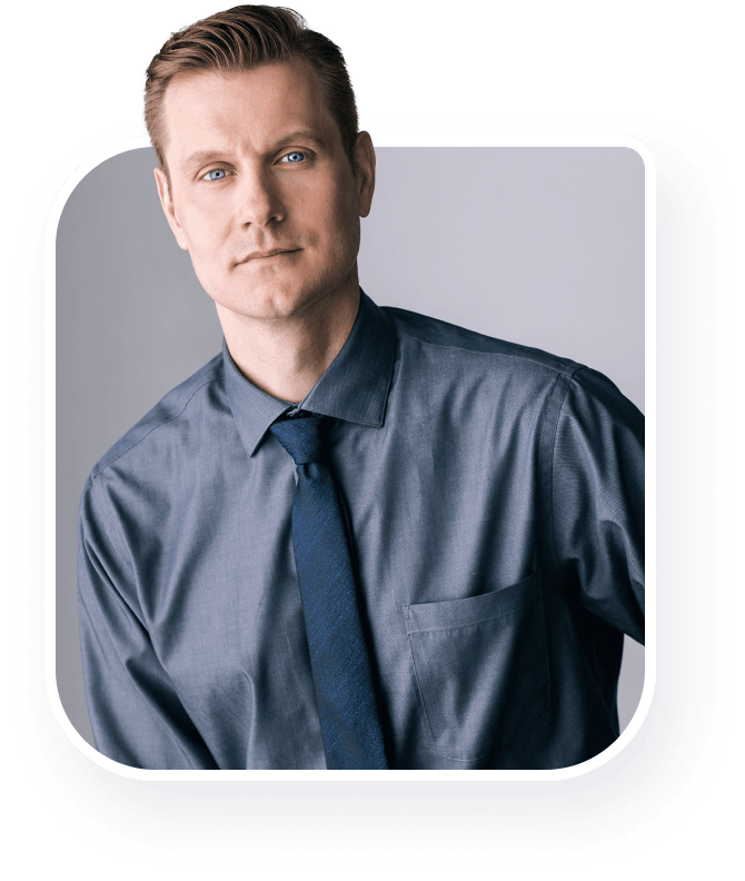 A Surrey Counselor in a blue shirt is posing for a photo.