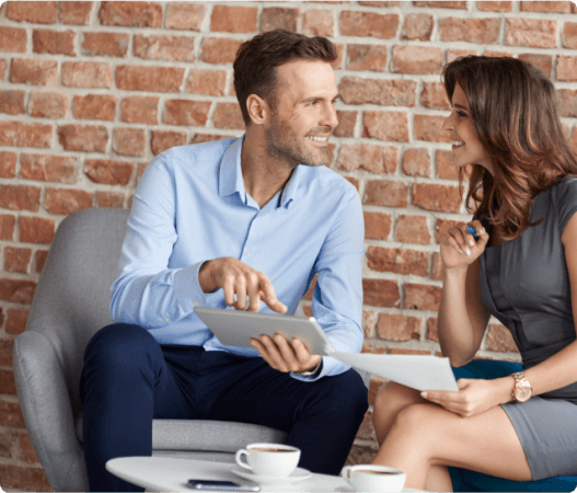 A couple engaged in therapy sessions with a tablet under the guidance of a clinical counselor.