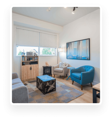 A living room furnished with blue chairs and a coffee table located in Surrey.