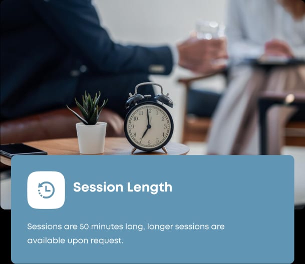 A Clinical Counsellor monitoring the session length of a client with an alarm clock on his desk.