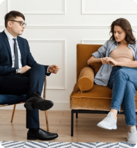 A couple receiving divorce counseling while sitting on a couch.