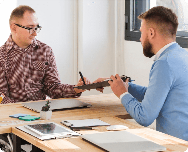 Two men engaging in divorce counseling at a desk.