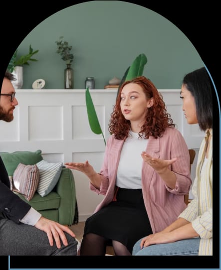 Three people engaging in a therapeutic conversation, addressing mental health concerns, while seated in a circle.