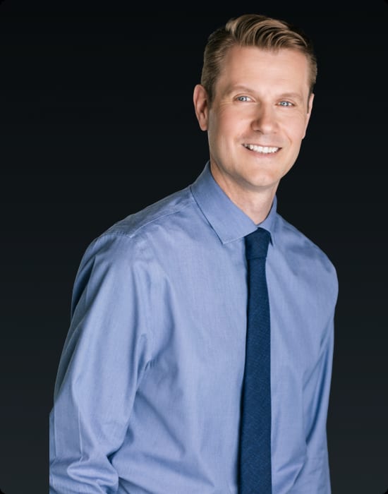 A Surrey counselor in a blue shirt and tie.