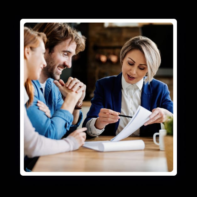 A group of Clinical Counsellors sitting around a table looking at papers.