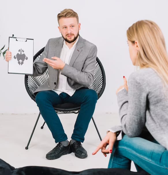 A Surrey counselor converses with a woman in a chair.