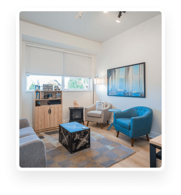A living room furnished with blue chairs and a coffee table located in Surrey.